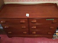 Front view of Vilas wooden dresser showing six drawers with wooden handles and curved top edge.