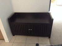 Front view of black wooden hall bench cabinet with double doors closed
