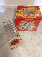 Pasta roller and ravioli maker boxes showing full packaging and branding