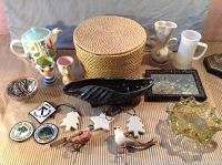 Overall view of all lot items on a flat surface including basket, egg cups, birds, trays, and ornaments