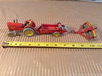 Full set showing red Massey Harris tractor, manure spreader, and disc harrow with measuring tape for scale.