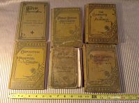 Photo showing all six vintage school books arranged in two rows with a ruler for scale.