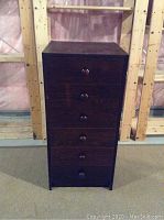 Full front view of the dark brown 6 drawer lingerie dresser showing the round wooden knobs and vertical drawer arrangement.