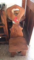 Wooden child's chair with heart cutouts on backrest and seat, painted cardinal bird detail on backrest