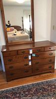 Front view of Ethan Allen dresser with attached mirror, showing drawer layout and wood finish.