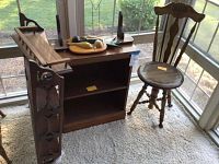 Photo showing the 4-shelf wall hanging display shelving, wooden display stand with rail detail and plate groove, wooden bookcase with one shelf, and the piano seat chair with carved details.