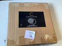 Closed cardboard box labeled Curtis Stone 2pc pizza pan set.