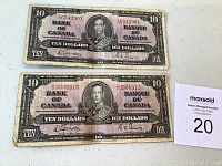 Front view of two 1937 Bank of Canada ten dollar bills placed one above the other on a white surface.