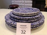 Stacked view of 11 Queens Malaysia plates with blue floral pattern showing different sizes layered