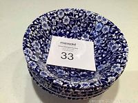 Stack of 6 blue and white floral bowls from a top angle showing intricate flower pattern