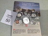 Uncirculated 1977 Royal Canadian Mint coin set sealed in plastic with informational card in English and French describing coin circulation and specifications.