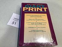 Photo of the Bible's front cover wrapped in plastic showing text about features like cross reference system, red-letter edition, introductions, presentation pages, concordance, and colorful maps.