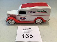 Side view of red and white vintage style collectible Guardian Drugs bank truck with I.D.A. decals