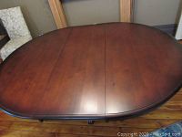 Top view of the vintage solid wood oval dining table showing minor scrapes on the tabletop surface.
