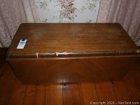 Full view of the cedar chest showing overall shape, color, and condition.