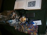 Mixed electronic accessories including cables, chargers, and small devices in plastic bags and loose.