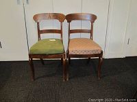 Front view of two dining chairs side by side, showing detached upholstered seats and cabriole legs.