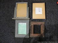 Four small frames on carpet background showing variations in size, material and condition