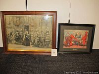 Two framed prints side by side on floor. The left print shows Queen Victoria in a procession, framed in oak. The right print shows men playing cards in a black frame.