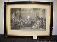 Front view of the framed print showing the entire artwork and frame with visible wear on black gesso frame.