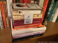 Stack of various books including 'Diana' by Andrew Morton, 'Don't Sweat the Small Stuff' and others