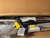 View inside the box showing mop head, extension rods and squeegee still packed.