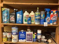 Photo of shelves holding multiple cleaning and automotive items including cleaners, motor oils, paint thinners, and sprays.