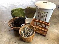 Photo showing the collection of storage and laundry items including baskets, cables, and towels.