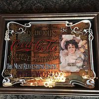 Full view of the framed Coca Cola mirror showing overall design, colors, and frame details.