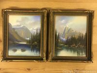 Pair of vintage framed pastels depicting mountain and lake scenes, gold decorative frames