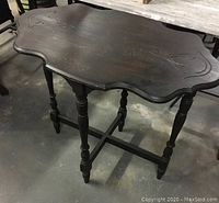 Front and top view showing the vintage wood table with oval shape and carved decorative detailing.