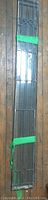 Full view of one leaded glass panel showing overall design and dimensions wrapped with green tape.