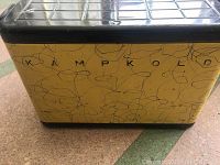 Front view showing yellow cooler body with black abstract squiggly line design and Kampkold brand name.