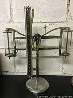 Front view of the metal and glass induction equipment with measurement scale and tubing attached.