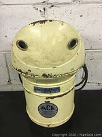 Front view showing yellow metal body with two protruding air vents and brand plaques.