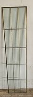 Full view of tall brass framed glass panel showing six beveled glass sections arranged in a 3 by 2 pattern.