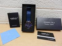 Full lot display including CRRJU box, watch in foam insert, user manual, cleaning cloth and guarantee card.