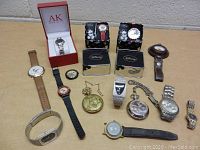 Full assortment of 12 watches including wristwatches and pocket watches on table surface.