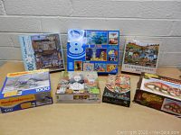 Photo showing all seven puzzle boxes in a group with visible images and piece counts.