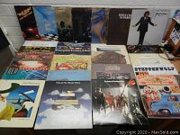 Sixteen albums leaning against wall including Bob Seger & The Silver Bullet Band, Traffic, Steely Dan, Carole King, Jesus Christ Superstar, Joe Cocker