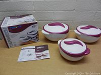 Photo showing the three containers with lids on, original box and instruction manual on table