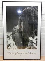 Frontal view of the framed black and white Ansel Adams picture with glass and black frame, showing the landscape and text at the bottom.