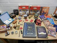 Wide view of the assorted Harry Potter items arranged on a table including puzzles, books, mugs, and collectibles
