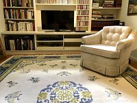 Full view of rug under chair and built-in bookshelf showing overall size and condition