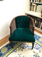 Front view showing chair seat, tufted back and wood legs
