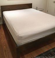 Queen size bed frame, angled view showing headboard and footboard