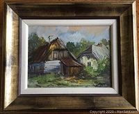 Framed oil painting depicting a Polish village with two houses, signed Scypt, with a broad brown/gold frame and white mat.