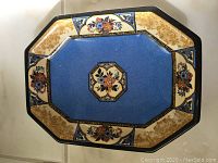 Top view of large blue rectangular Wedgwood ornamental plate with floral and gold decorative borders