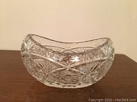 Photo of large crystal bowl with detailed cut patterns on wooden surface