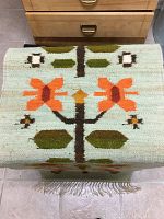 Top view of folded kilim showing folk-floral design